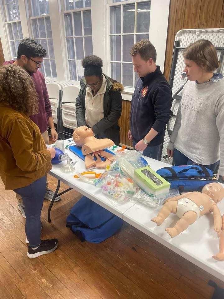 Vital Life CPR class with students at training table
